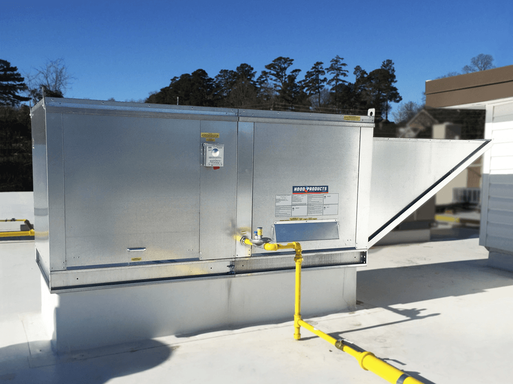 Technician inspecting commercial kitchen exhaust hood