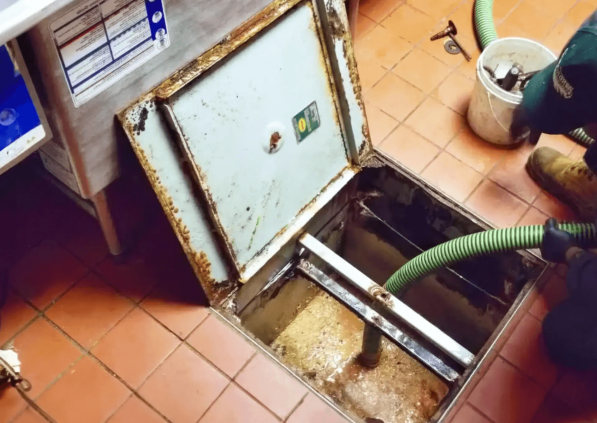 Technician inspecting commercial kitchen exhaust hood