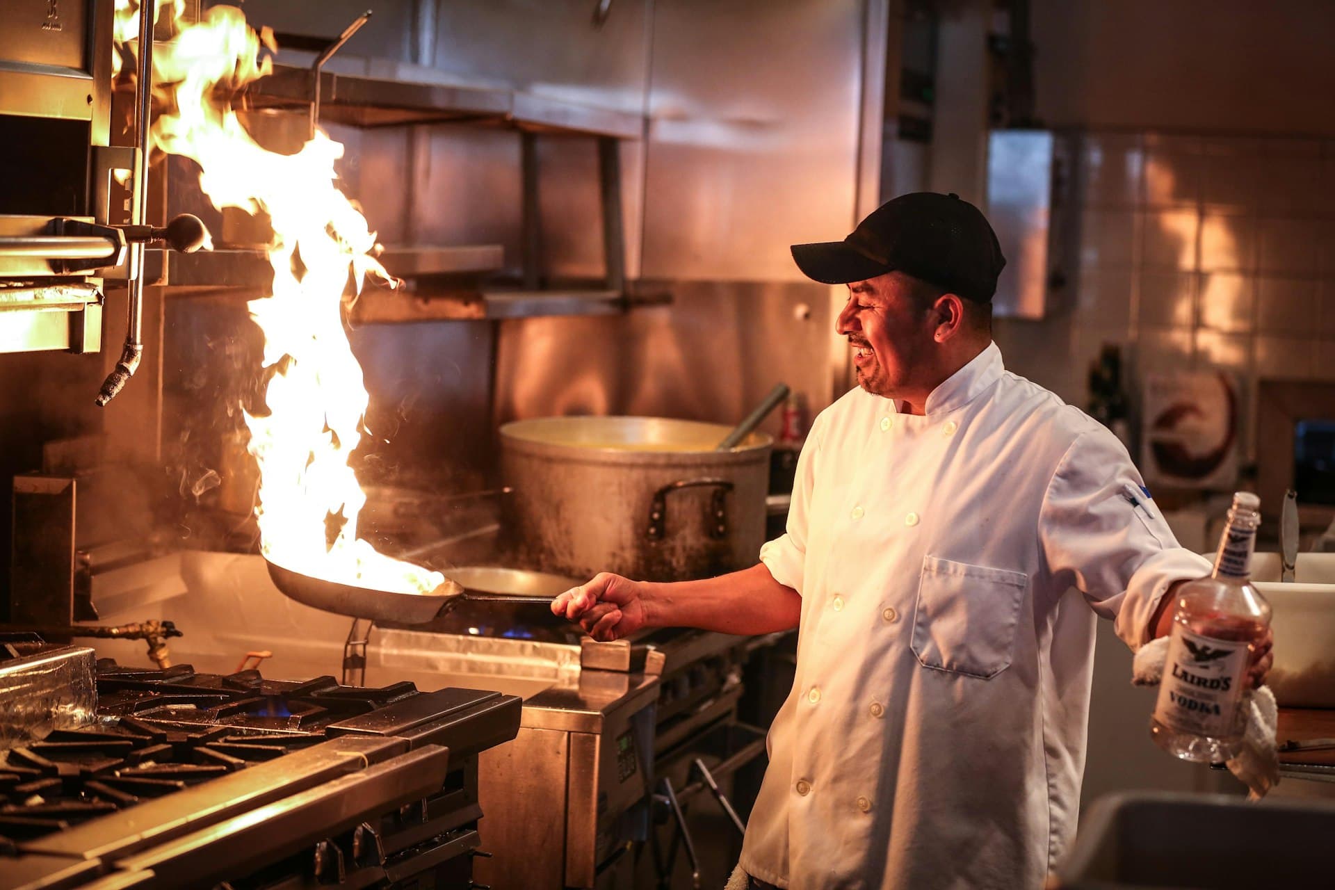 Qwick Services And Solutions technicians servicing a commercial kitchen exhaust hood