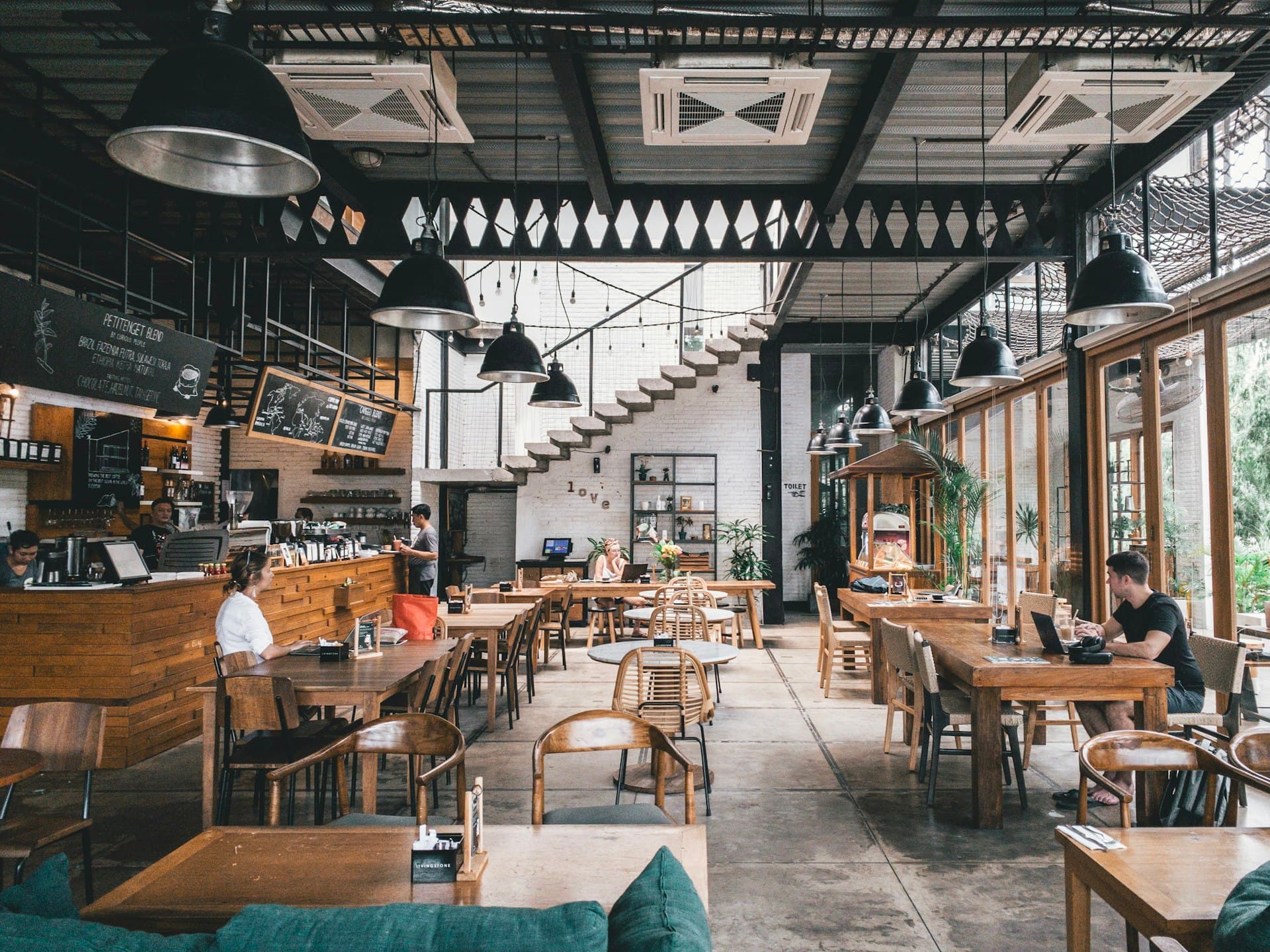Commercial restaurant kitchen with stainless steel hoods and prep stations