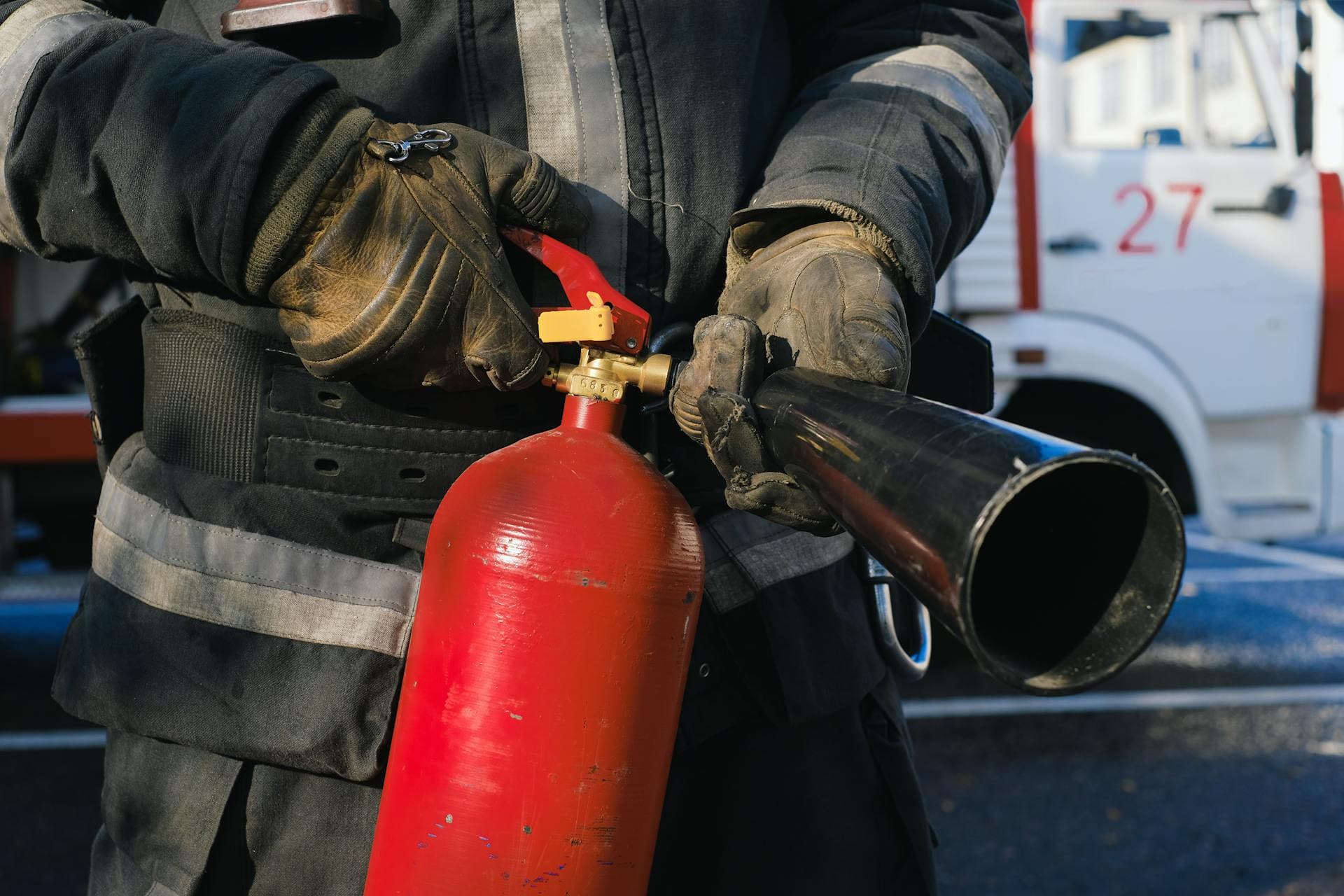 Commercial kitchen fire suppression nozzles above cooking equipment